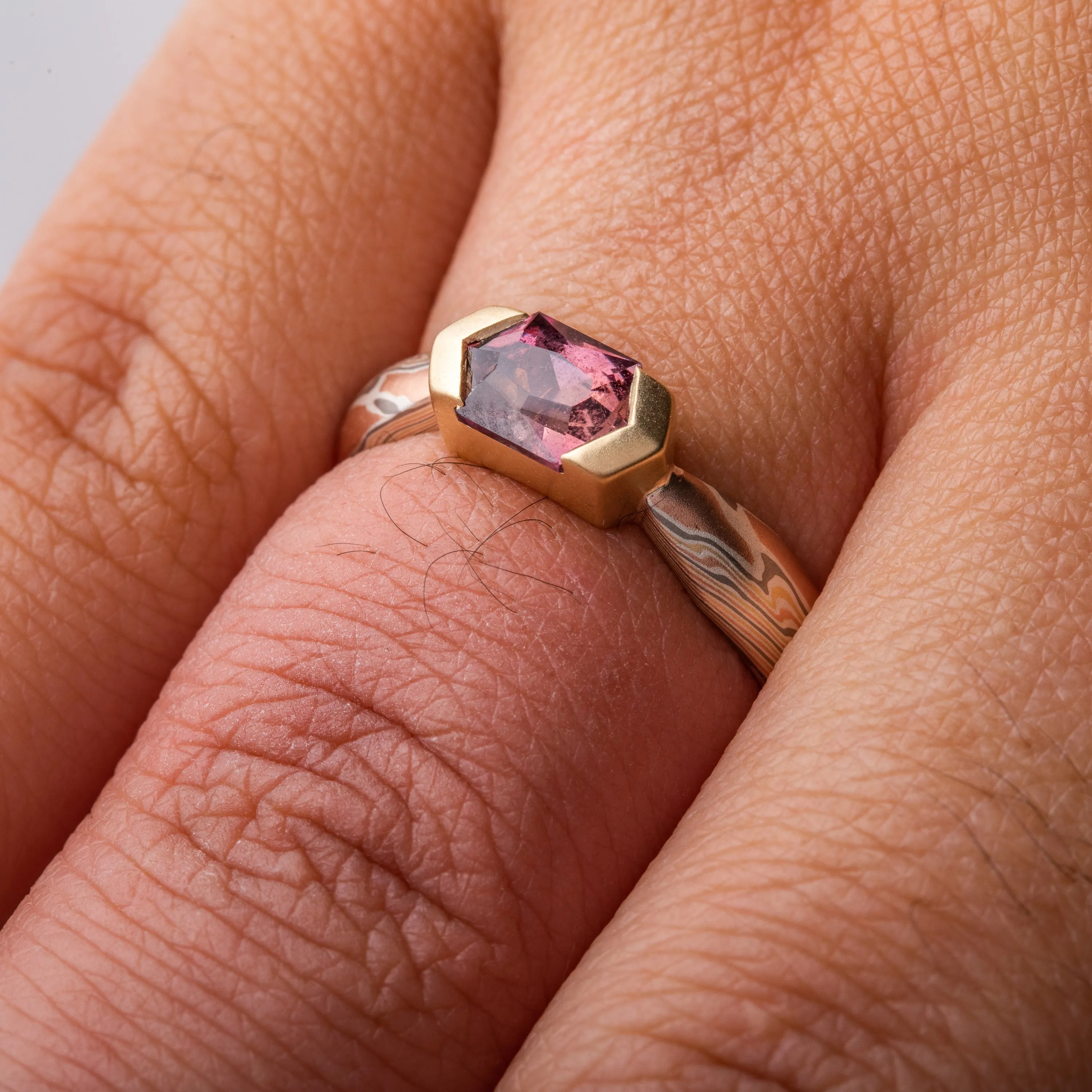Enchanting Mokume Twist Pattern Ring with Dusky Rose Sapphire