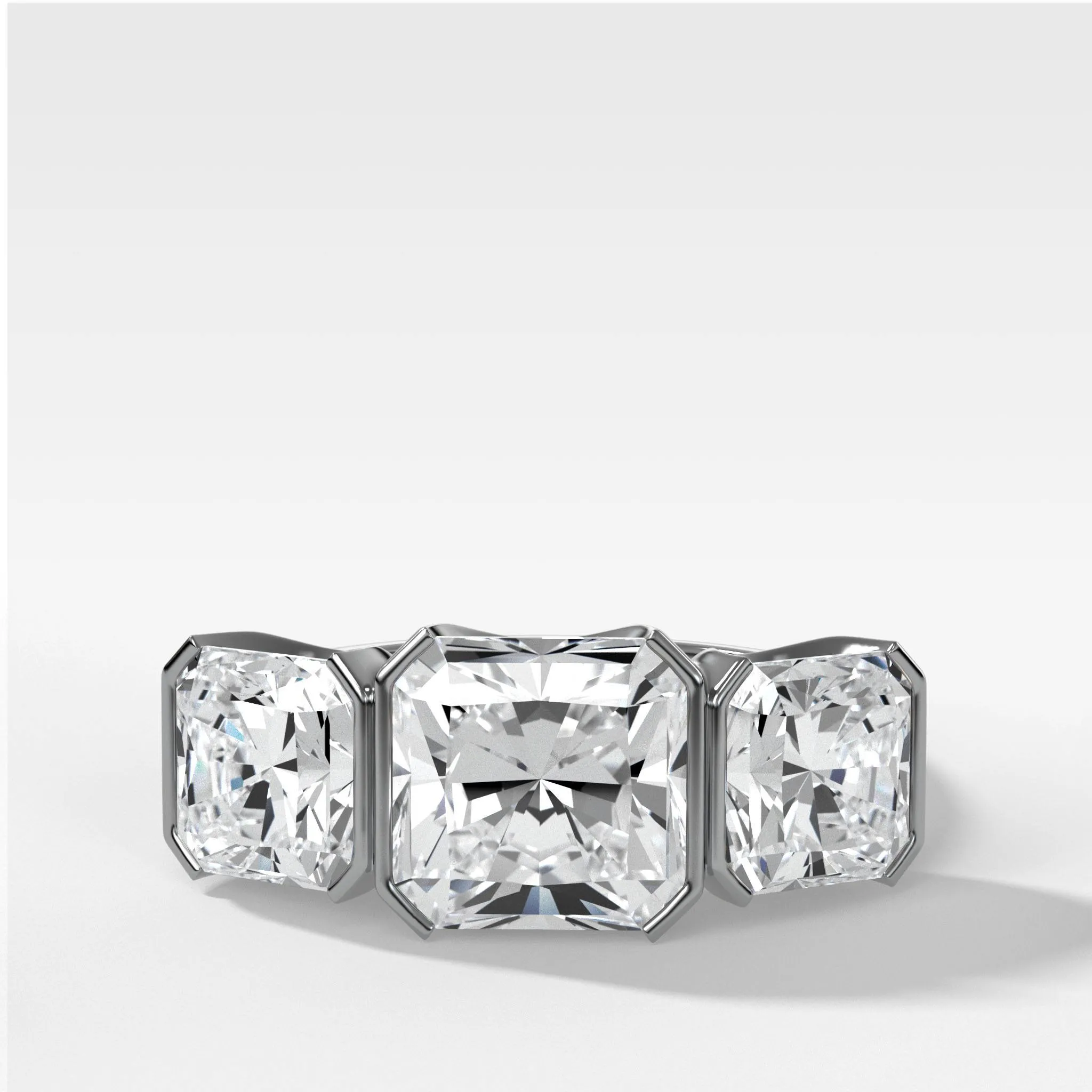 Half Bezel Triad Engagement Ring With Radiant Square Cut Diamonds